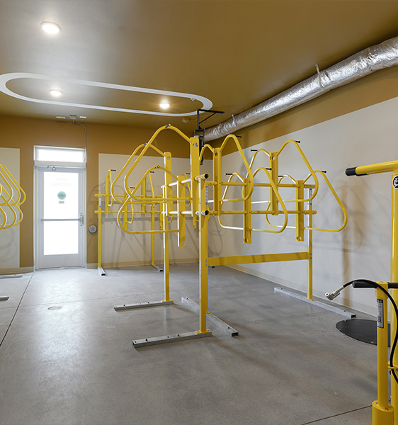 community bike lock area inside of the building with a tire pump.