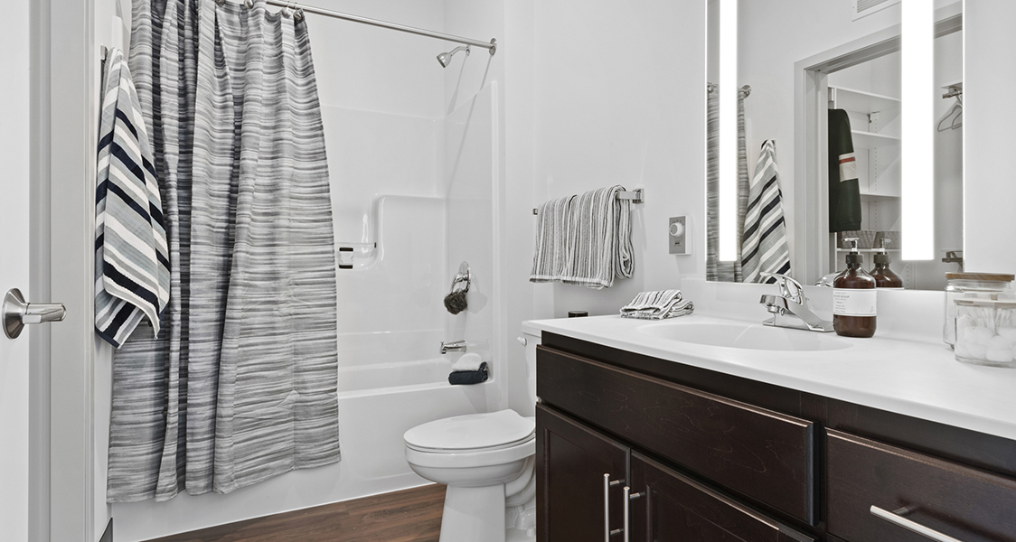 the bathroom with a shower, toilet and sink