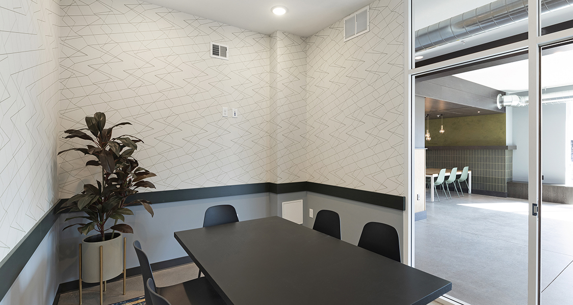 the common areas meeting room with several chairs and a conference table