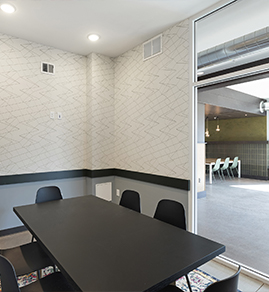 the common areas meeting room with several chairs and a conference table